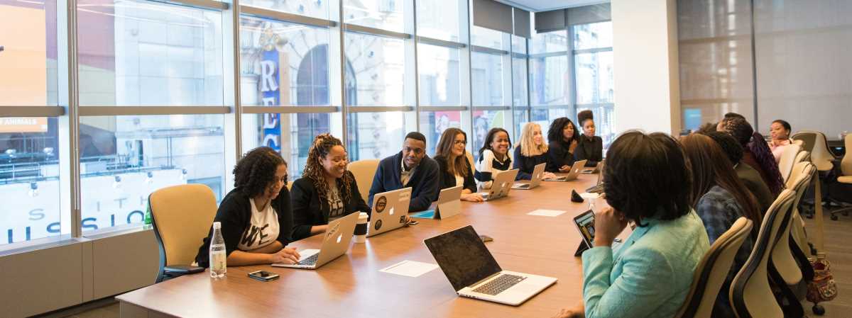 This is a picture of people working together around a conference table.